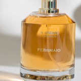 a person holding a bottle of perfume in their hand