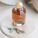 a bottle of perfume sitting on top of a white plate