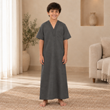 Boy wearing the dark gray jalabiya