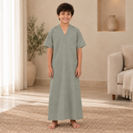 Boy wearing the gray-green jalabiya
