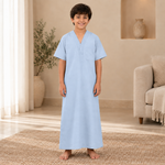 Boy wearing the light blue jalabiya