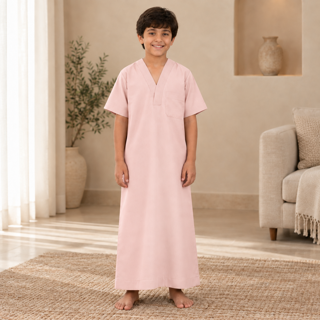 Boy wearing the light pink jalabiya
