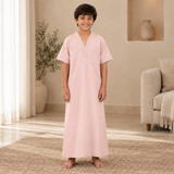Boy wearing the light pink jalabiya