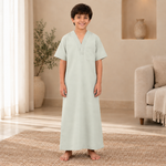 Boy wearing the pale gray-green jalabiya