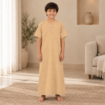 Boy wearing the warm sandy beige jalabiya