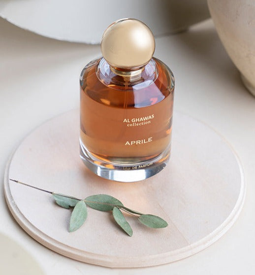 a bottle of perfume sitting on top of a white plate